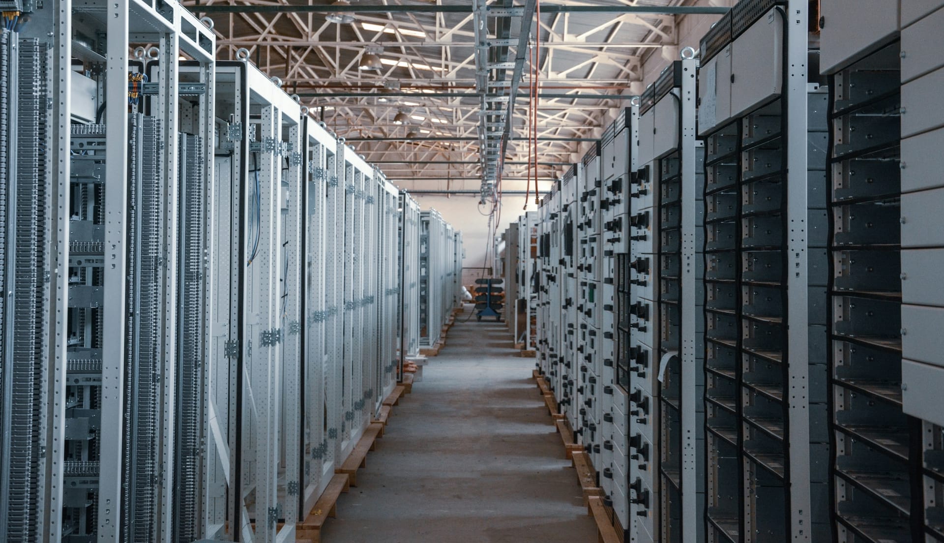 A server room aisle with metal equipment racks